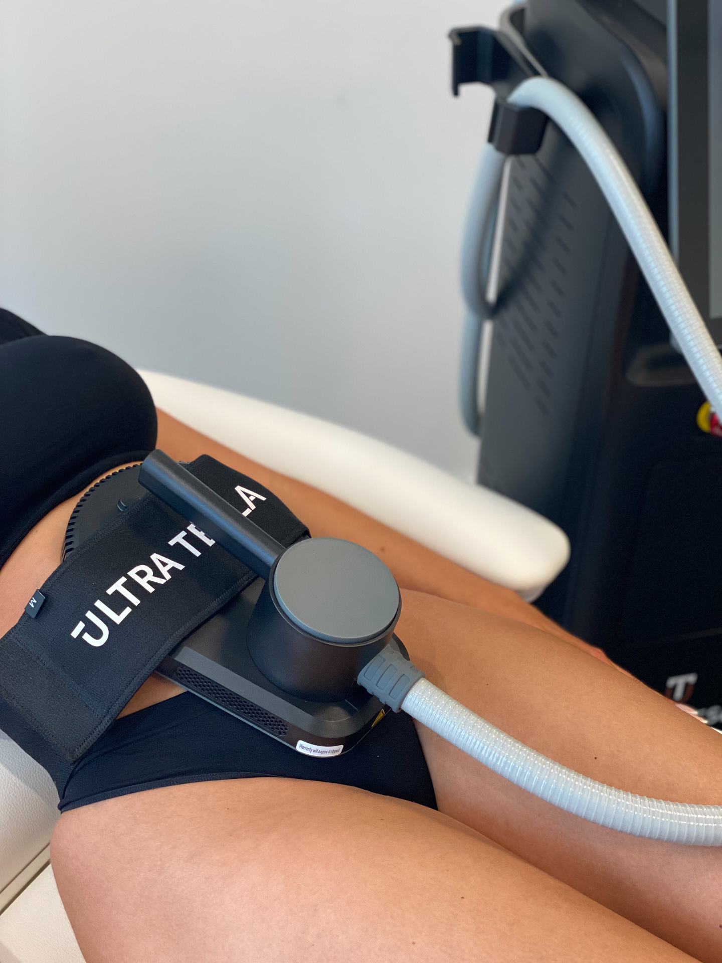 Close-up of Ultra Tesla body sculpting treatment on the abdomen