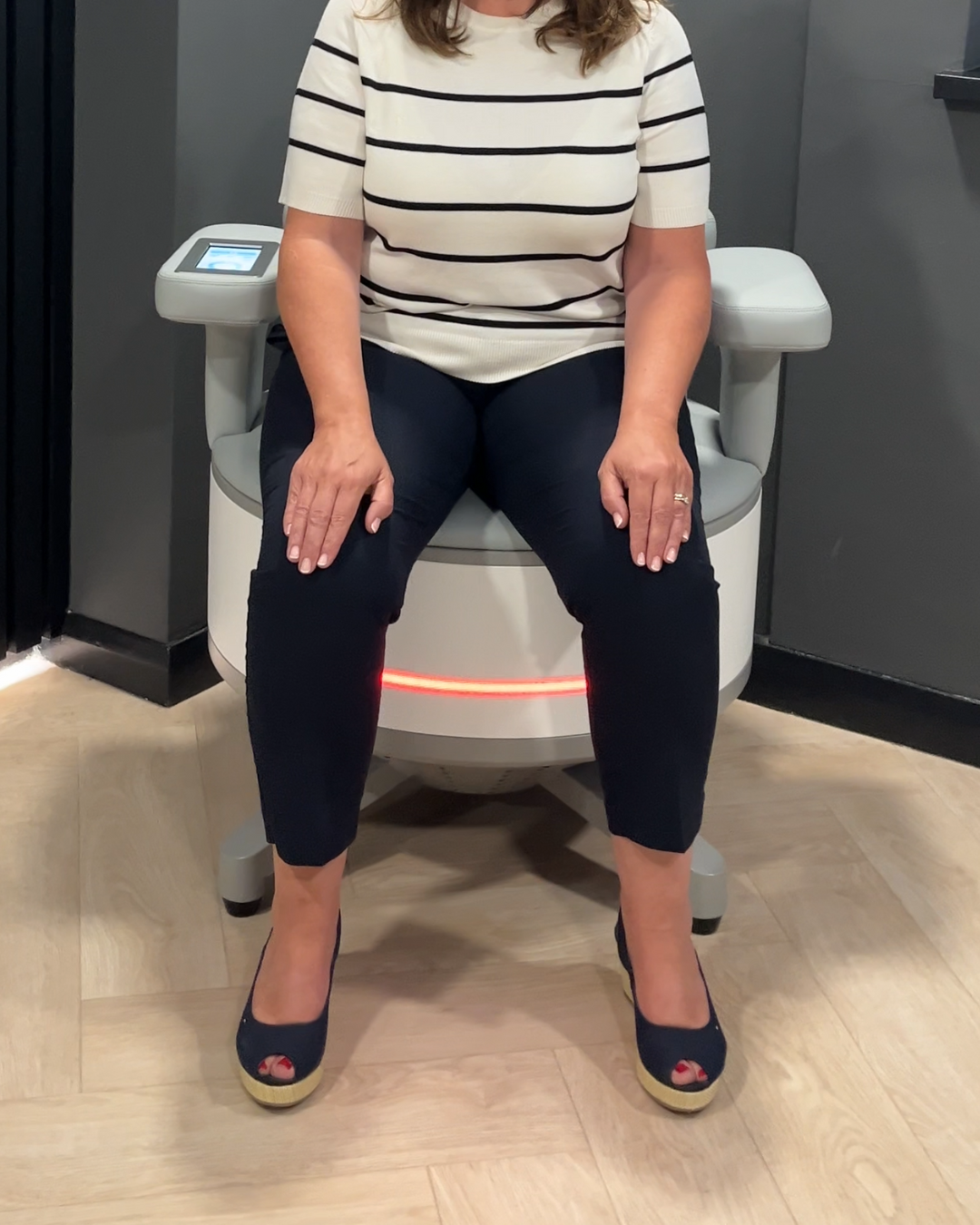 Client receiving Ultra Tesla Seat treatment, fully clothed